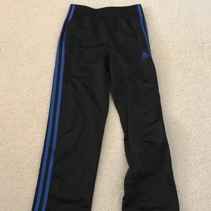 Black adidas pants with blue stripe